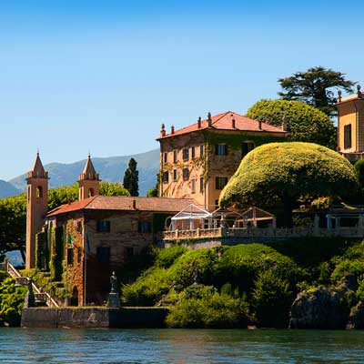 Luxury lake house in Tuscany, Italy managed by TurnKey, featuring beautiful architecture and stunning views of the surrounding hills and waterfront.